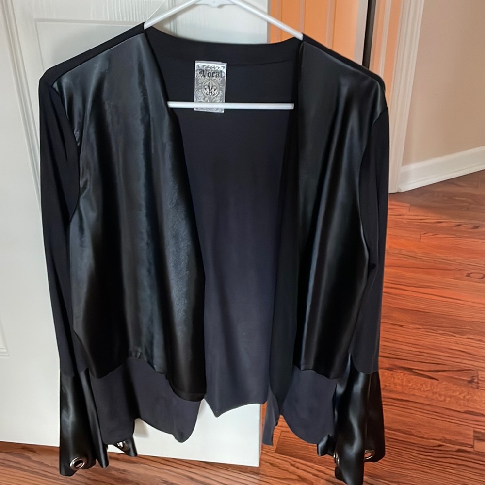Lightweight jacket with wide sleeves and grommets on the end.